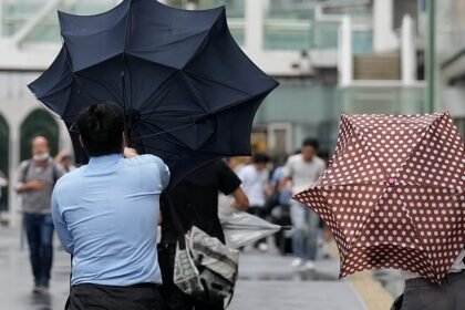 Flooded streets and rescues as Typhoon Dujuan hits Japan