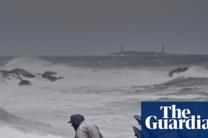 Power outages and flooded roads as major storm bears down on US north-east