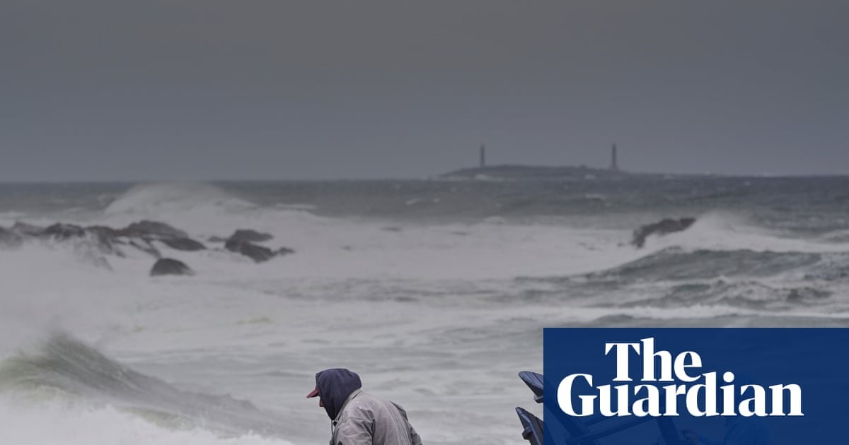 Power outages and flooded roads as major storm bears down on US north-east