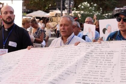 Priests Against Genocide hold shroud with names of children killed in Gaza
