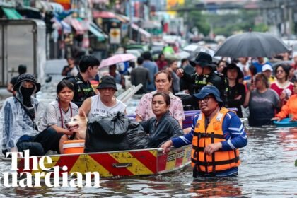 Bangkok residents navigate streets by boat as flood waters rise