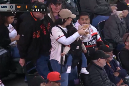 Multi-tasking mom seen juggling baby and snacks at Giants game defends husband after internet attacks