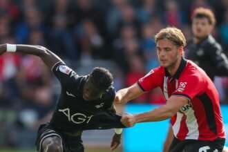 Swansea go top after victory at Lincoln