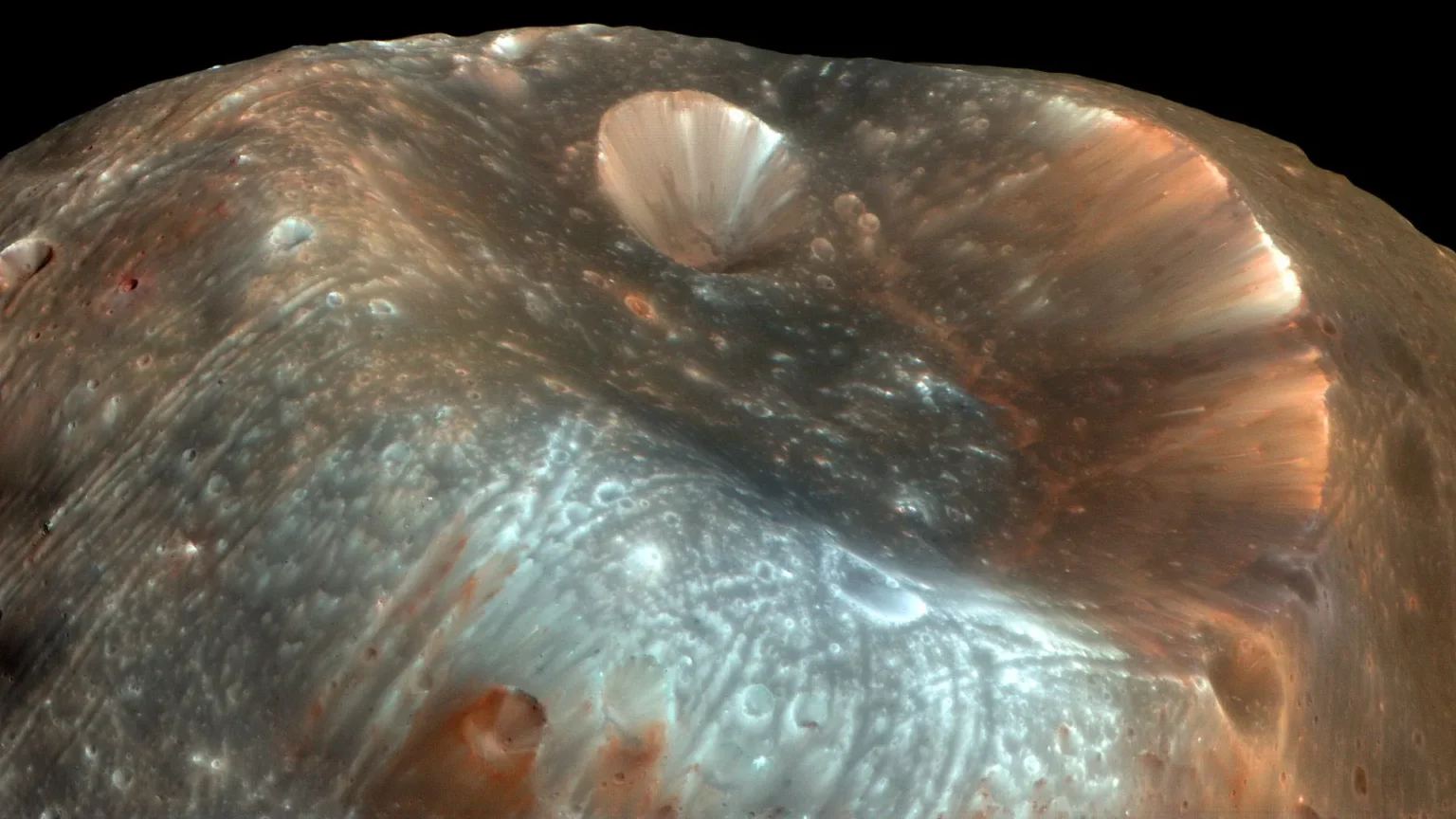 A giant crater may reveal the origin of Mars’ doomed moon