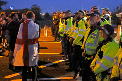 Protesters gather as migrants brought ashore on south coast