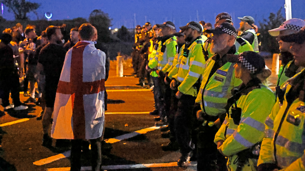 Protesters gather as migrants brought ashore on south coast