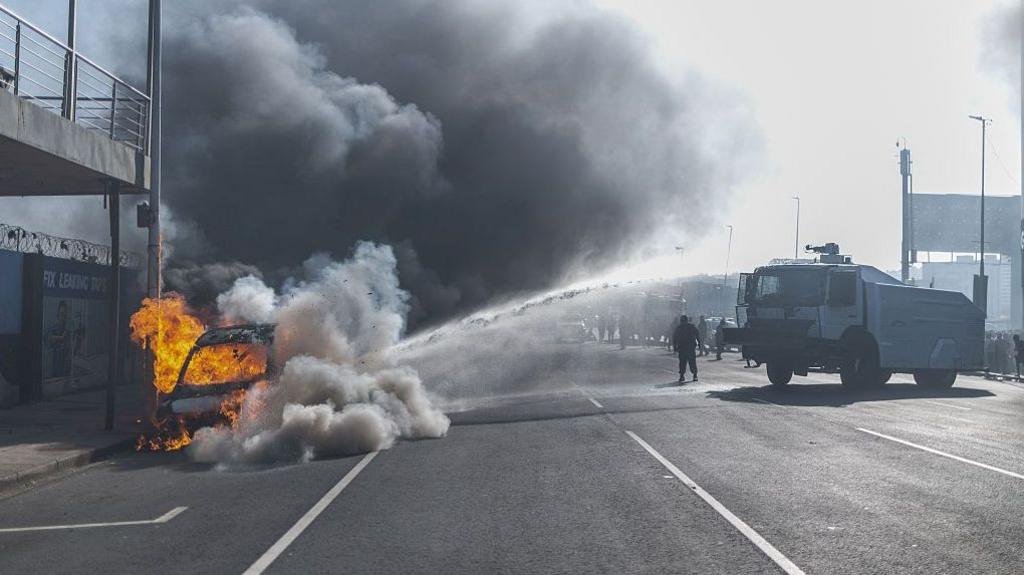 Cars torched and shops looted as anti-migrant violence erupts in South Africa