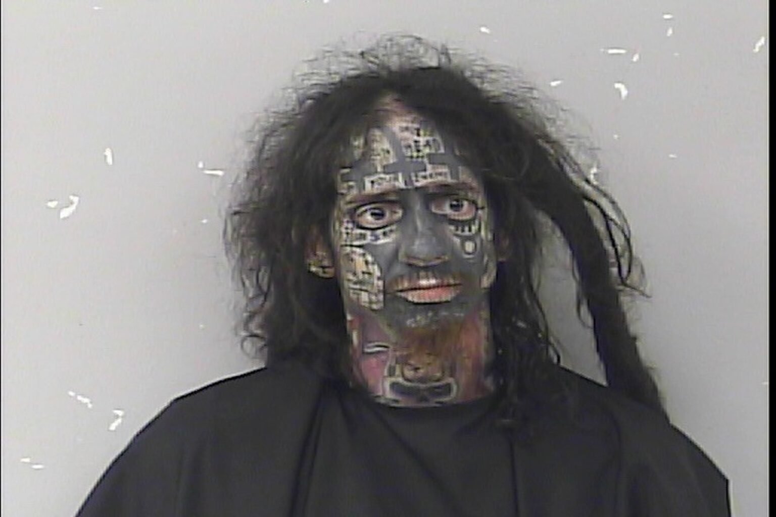 Bizarre mugshot shows ‘demonologist’ accused of tracking women by their phones