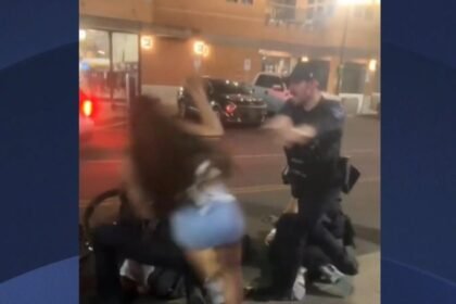 Video shows cheerleader shoved to the ground by police