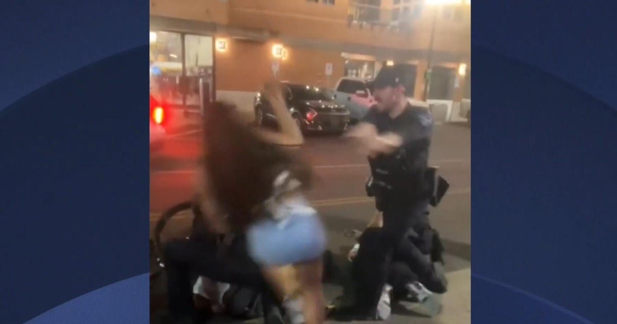 Video shows cheerleader shoved to the ground by police