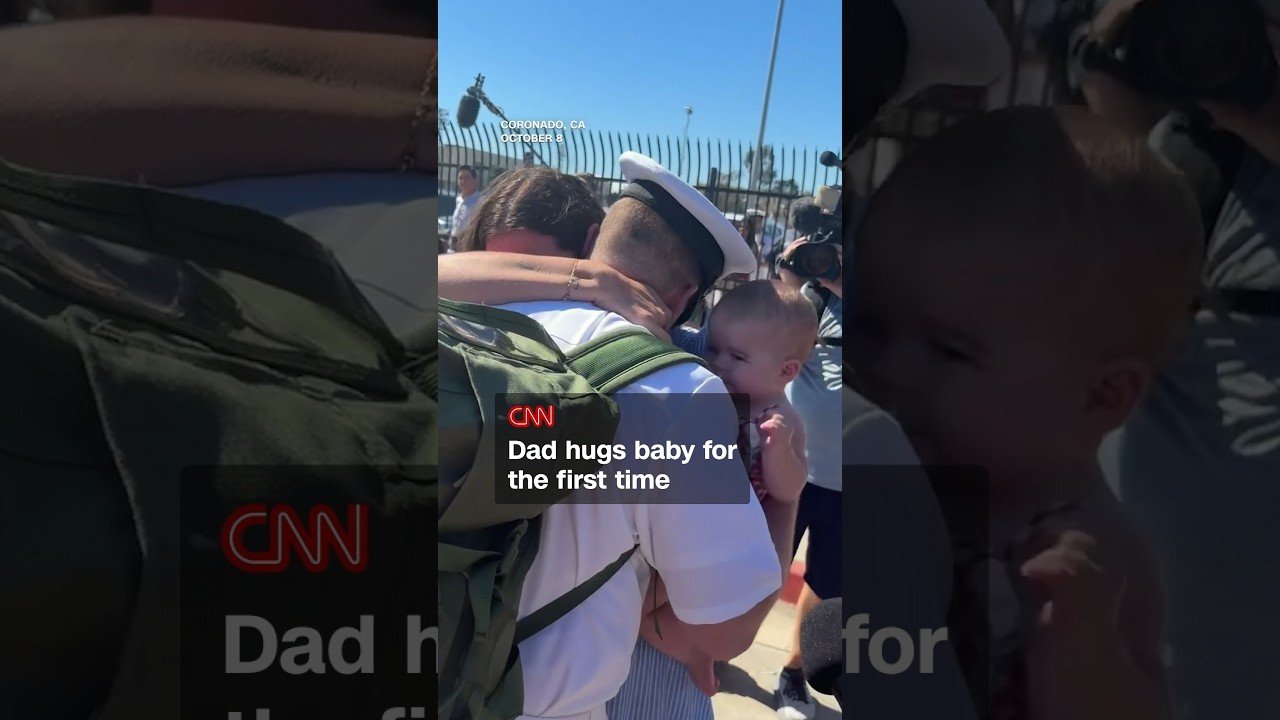 Dad hugs baby for the first time