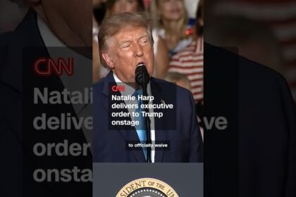 Natalie Harp delivers executive order to Trump onstage
